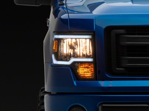 Raxiom 09-14 Ford F-150 Axial Series Headlight w/ SEQL LED Bar- Black Housing (Clear Lens)