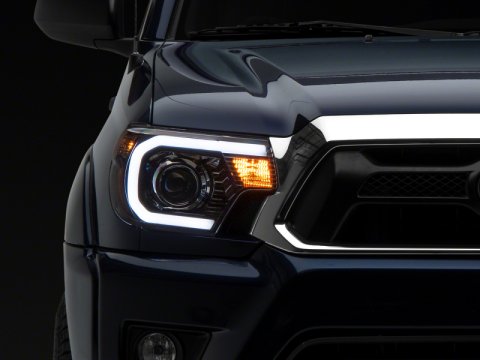 Raxiom 12-15 Toyota Tacoma Axial Projector Headlights w/ SEQL LED Bar- Black Housing (Clear Lens)