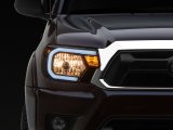 Raxiom 12-15 Toyota Tacoma Axial Series Headlights w/ LED Bar- Black Housing (Clear Lens) thumbnail 1