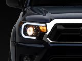 Raxiom 12-15 Toyota Tacoma Axial Series Projector Headlights w/ LED Bar- Black Housing (Clear Lens) thumbnail 1